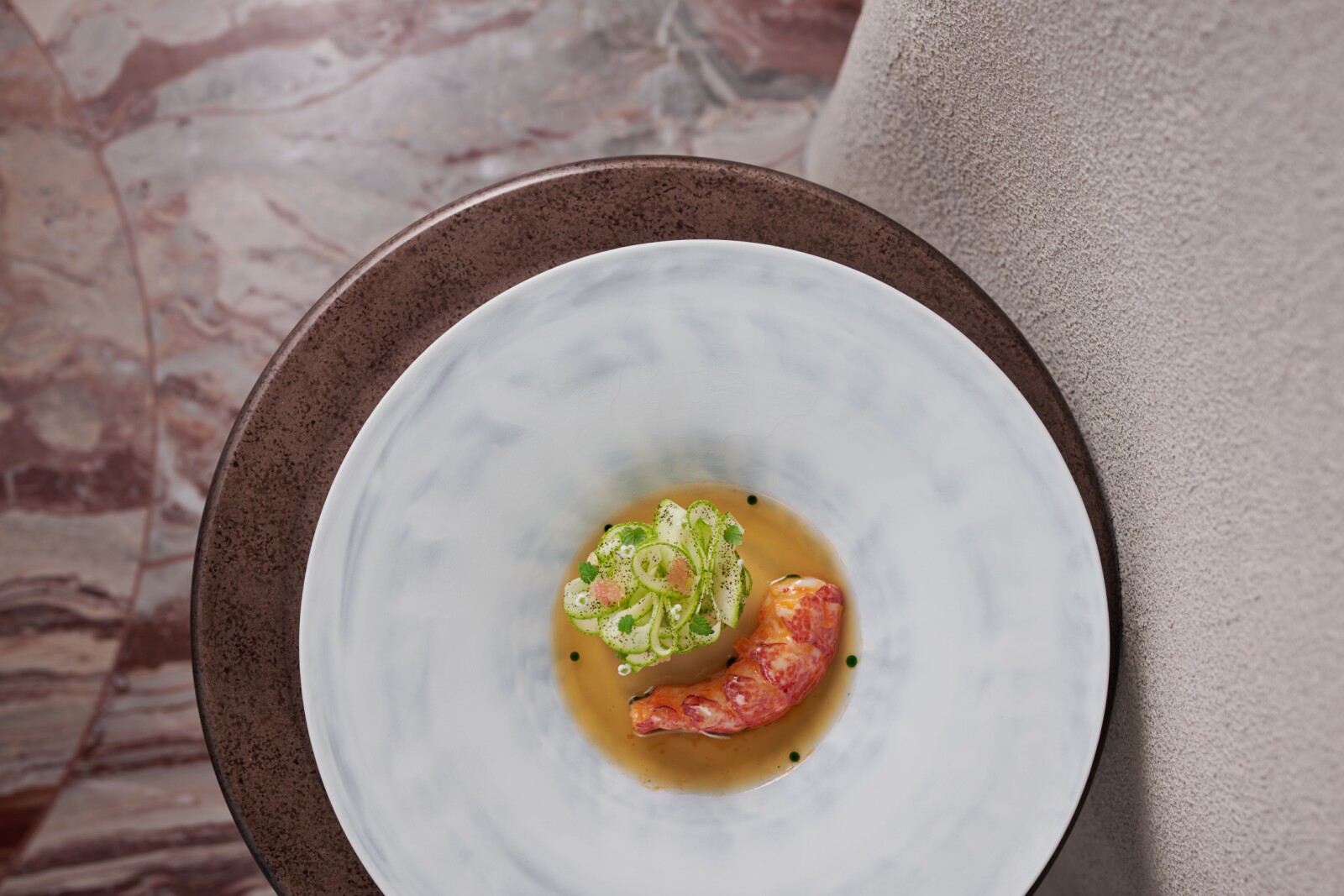Blue lobster poached in lobster butter arrives with a fermented pineapple brunoise and a trio of zucchini textures; lifted by a shellfish consommé giving sweet, tangy notes.