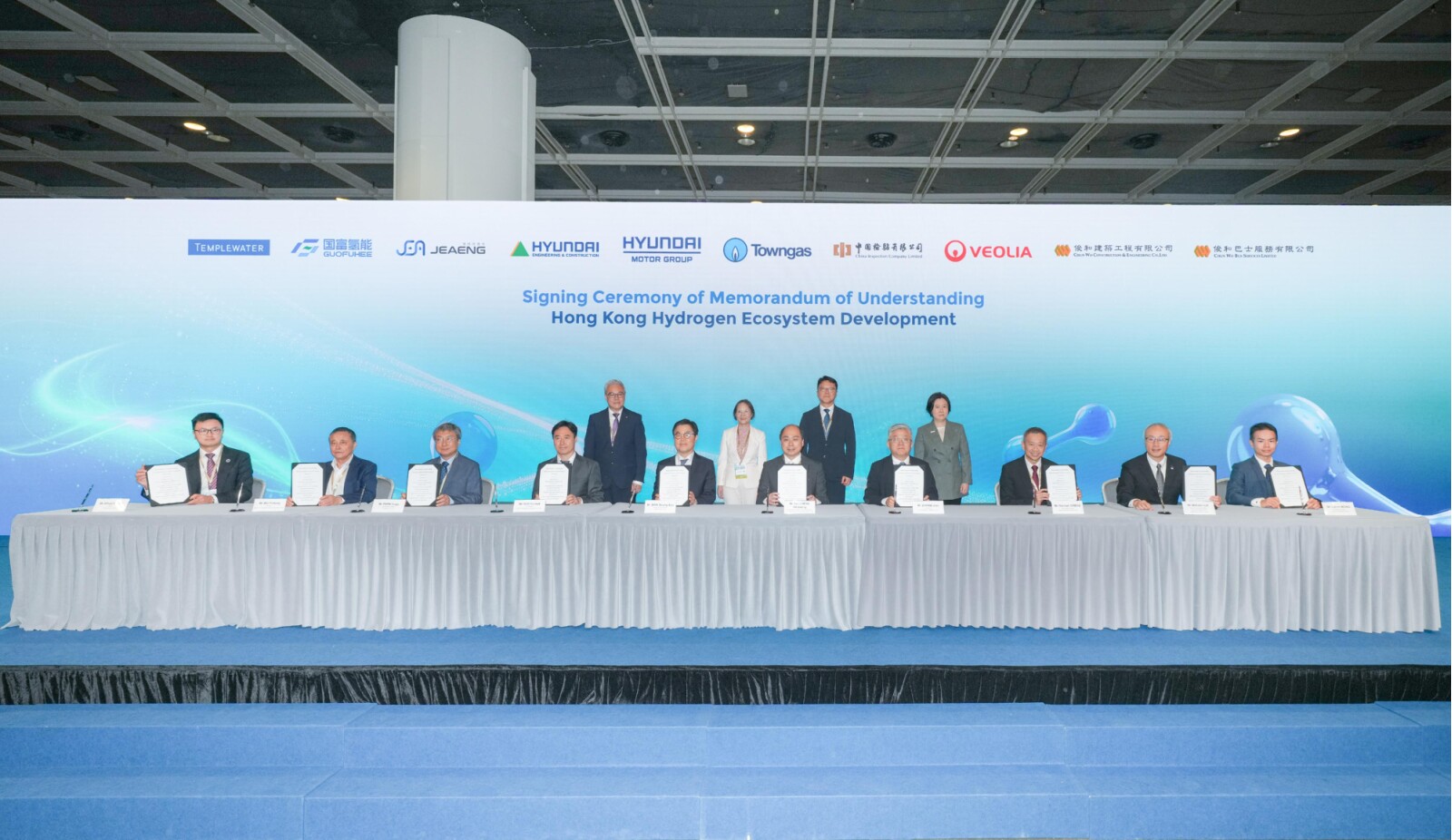At the International Hydrogen Development Symposium 2026 today (May 18), nine pioneering companies from Korea, the Chinese Mainland, France, and Hong Kong - including Hyundai Motor Group - signed a landmark Memorandum of Understanding on hydrogen ecosystem building, marking a major step toward advancing the city's green economy. Photo shows Deputy Minister for Territorial and Urban Policy at Ministry of Land, Infrastructure and Transport of the Republic of Korea, Mr Jeong Eui-kyung (back row, second right); the Acting Secretary for Environment and Ecology, Miss Diane Wong (back row, second left); the Director of Electrical and Mechanical Services, Mr Poon Kwok-ying (back row, first left); and the Director-General of Investment Promotion of Invest Hong Kong, Ms Alpha Lau (back row, first right), witnessing the signing.