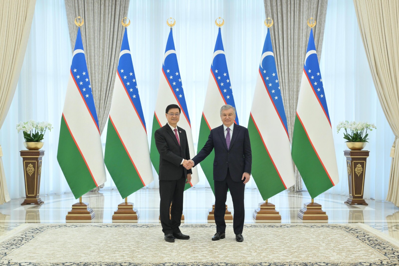 Hong Kong SAR's Chief Executive, John Lee (left) meets with the President of Uzbekistan, Shavkat Miromonovich Mirziyoyev.